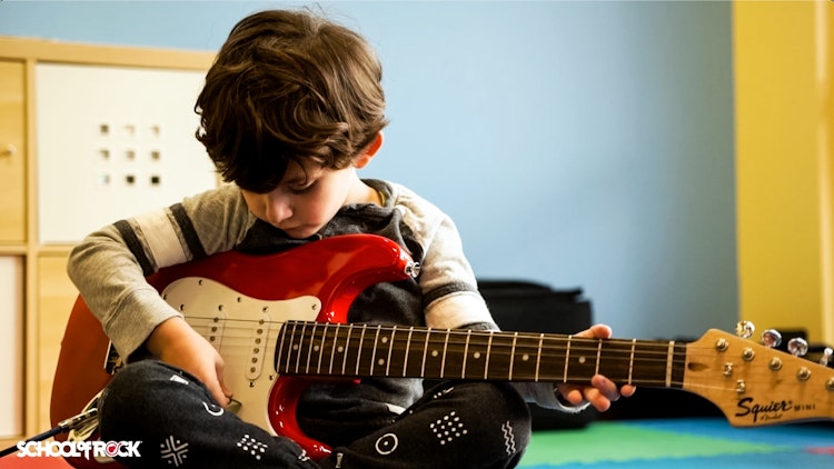 Student playing in music program for second graders