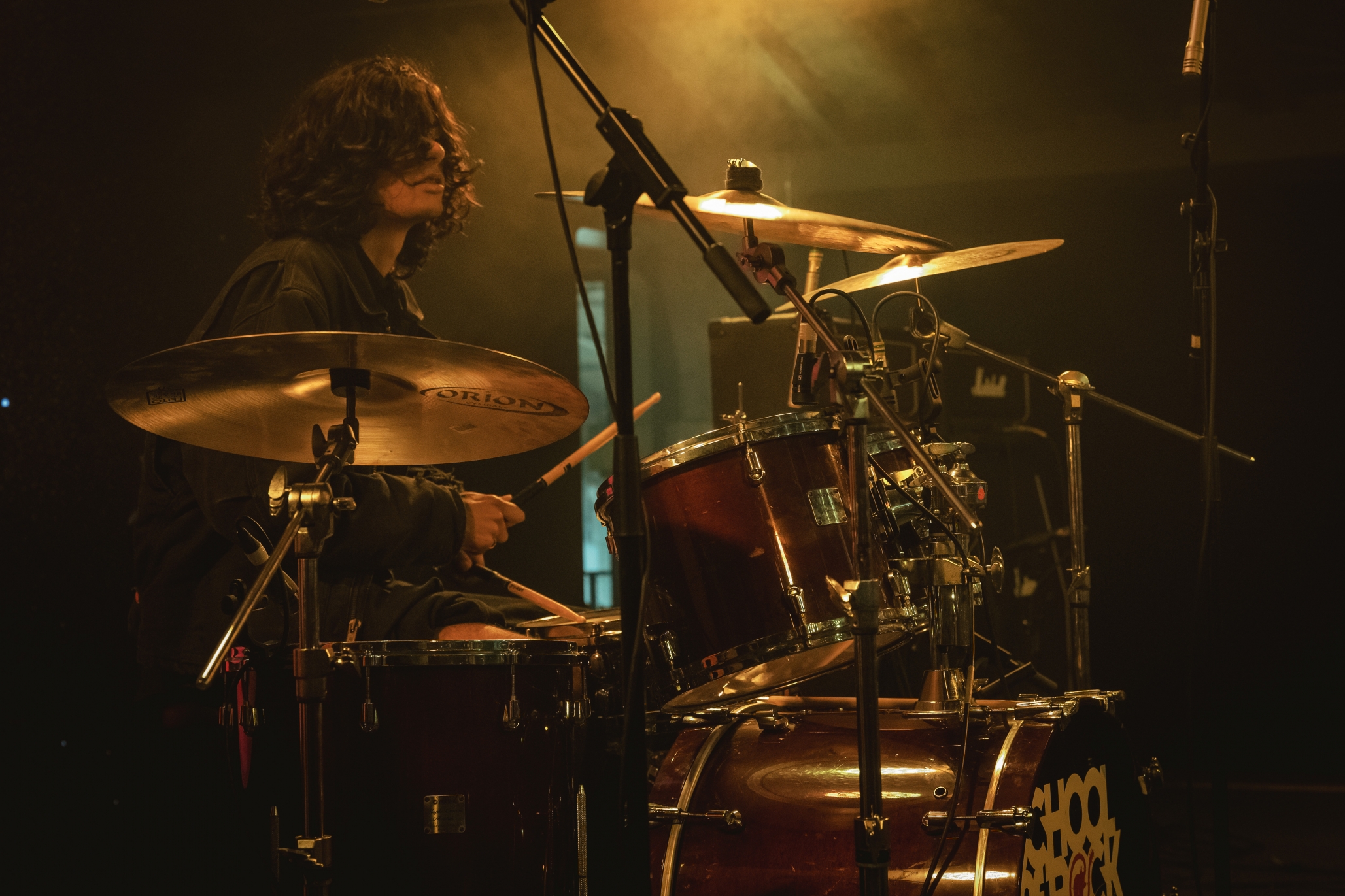 A School of Rock drum student on stage