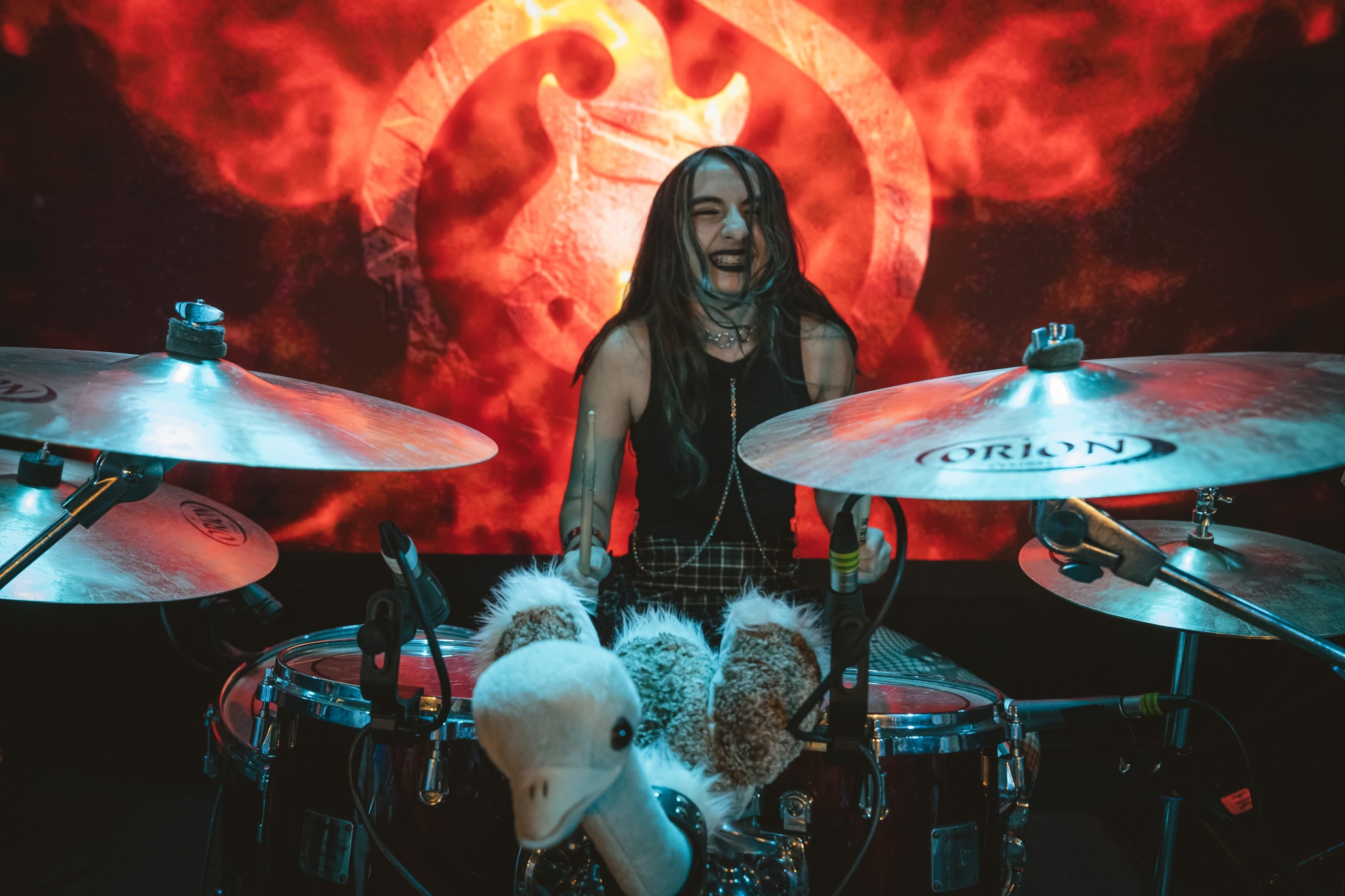 School of Rock drum student smiling while performing on stage
